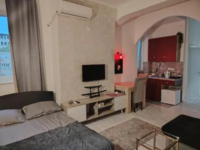 a living room with a bed and a kitchen at Pablo MovieSTAR in Belgrade