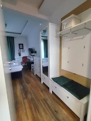 a room with a bed and a sink and a desk at Benvenuti MOON in Belgrade