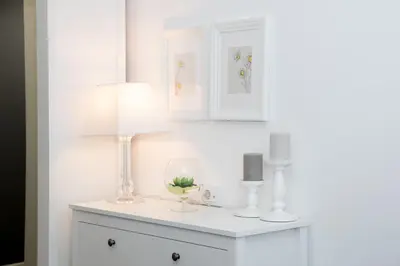 a white room with a table with a lamp at Benvenuti MOON in Belgrade