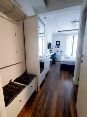 a room with a bedroom with a bed and a mirror at Benvenuti STAR in Belgrade