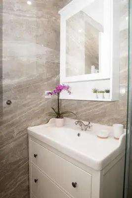 a bathroom with a white sink and a mirror at Benvenuti STAR in Belgrade