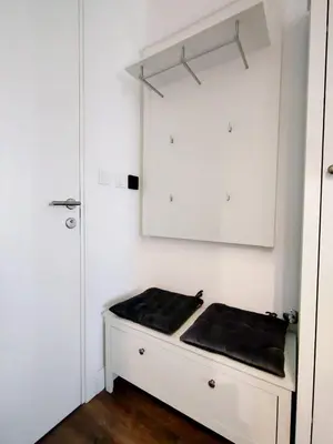 a white cabinet with a black cushion on top of it at Benvenuti STAR in Belgrade