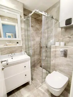 a bathroom with a shower and a toilet and a sink at Benvenuti STAR in Belgrade