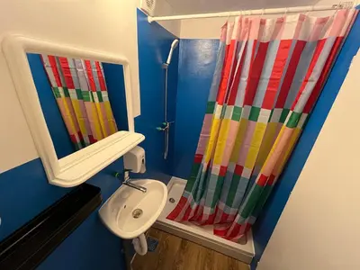 a bathroom with a colorful shower curtain and a sink at Chillton hostel in Belgrade