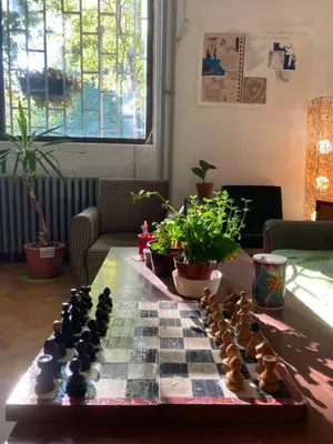 a chess board on a table in a living room at Chillton hostel in Belgrade