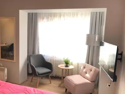 a living room with a chair and a chair at ZeMoon Apartment in Belgrade