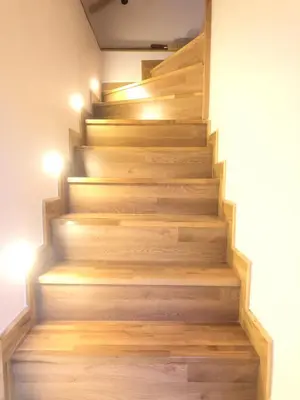 a staircase in a house with wooden floors and lights at ZeMoon Apartment in Belgrade