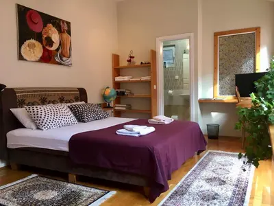 a bedroom with a bed with two towels on it at ZeMoon Apartment in Belgrade