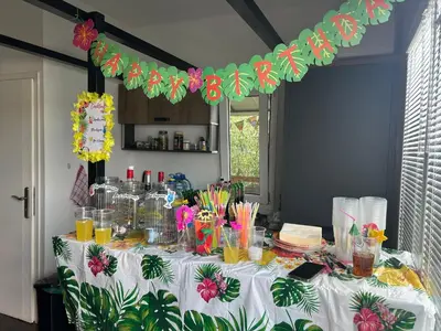 a table with a white table cloth with flowers on it at Splav na Savi - House on the river in Ostrvo Sprud