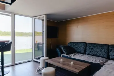 a living room with a couch and a table at Splav na Savi - House on the river in Ostrvo Sprud