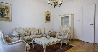 a living room with couches and chairs and a table at Apartment in city center of Belgrade in Belgrade