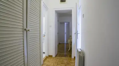 a hallway with a white door and a hallwayngth at Apartment in city center of Belgrade in Belgrade
