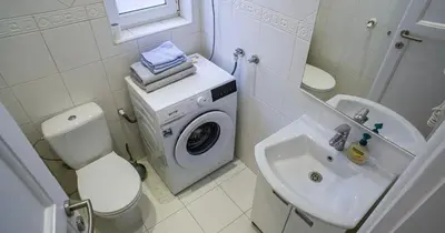 a bathroom with a washing machine and a sink at Apartment in city center of Belgrade in Belgrade