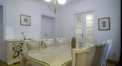 a white dining room with a table and chairs at Apartment in city center of Belgrade in Belgrade