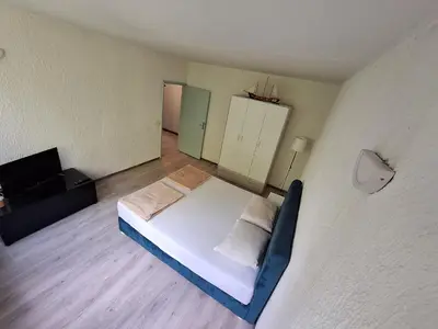 a small room with a bed and a television at Stan na dan Banovo brdo in Belgrade