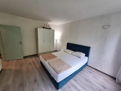 a bedroom with a bed and a cabinet in it at Stan na dan Banovo brdo in Belgrade