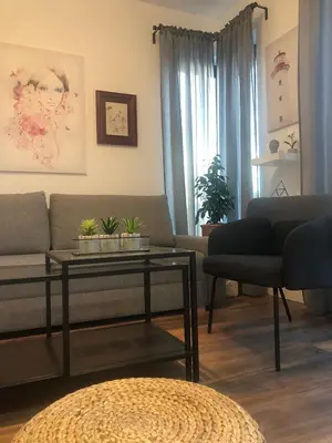 a living room with a couch and a table at Benvenuti FAMILY in Belgrade