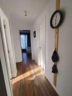 a hallway with a clock hanging on a wall at Benvenuti FAMILY in Belgrade