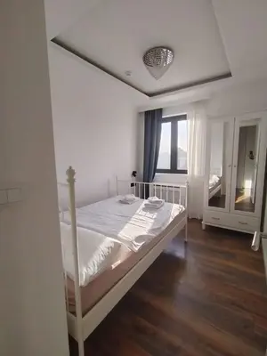 a bedroom with a bed and a window at Benvenuti FAMILY in Belgrade
