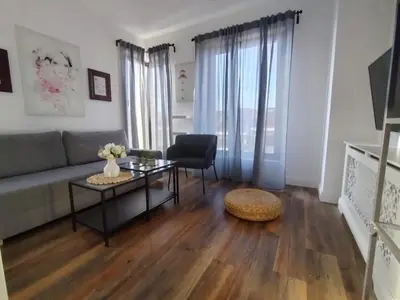a living room with a couch and a table at Benvenuti FAMILY in Belgrade