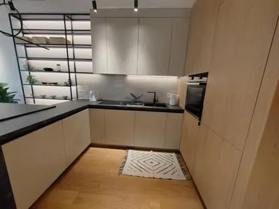 a kitchen with white cabinets and a sink and a floor at New Luxury Suite with Garrage in Belgrade