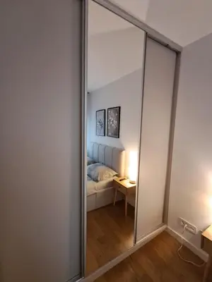 a large mirror in a room with a bed at New Luxury Suite with Garrage in Belgrade