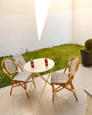 two chairs and a table with two cups on it at Cozy Work-Friendly flat with Backyard near forest in Belgrade