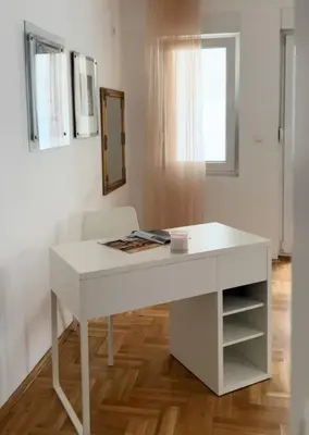 a white desk in a room with a window at Cozy Work-Friendly flat with Backyard near forest in Belgrade