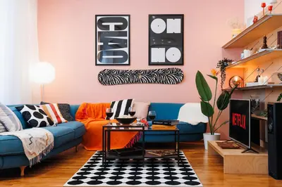 a living room with a blue couch and a pink wall at Colored Happiness 115m2 with Balcony Old Town in Belgrade