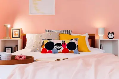 a bedroom with a white bed with colorful pillows at Colored Happiness 115m2 with Balcony Old Town in Belgrade