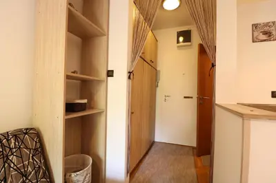 a room with a hallway with a door and shelves at Studio Apartman Vladar in Belgrade