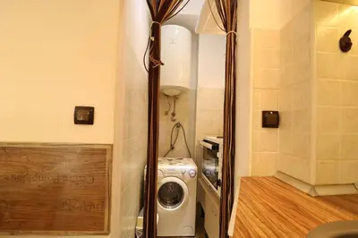 a small laundry room with a washer and dryer at Studio Apartman Vladar in Belgrade