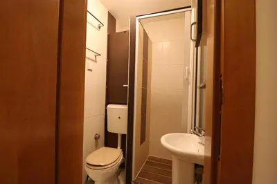 a small bathroom with a toilet and a sink at Studio Apartman Vladar in Belgrade