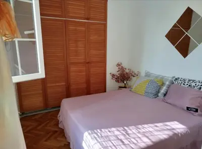a bedroom with a bed and a wooden door at on top of the city in Belgrade
