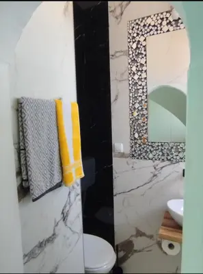 a bathroom with a sink and a mirror and a toilet at on top of the city in Belgrade