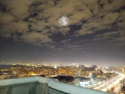 a view of a city at night with a moon at on top of the city in Belgrade