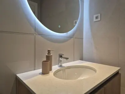 a bathroom with a sink and a mirror at Q4, flat near Gallery shopping mall with garage in Belgrade