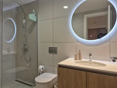 a bathroom with a toilet and a sink and a mirror at Q4, flat near Gallery shopping mall with garage in Belgrade