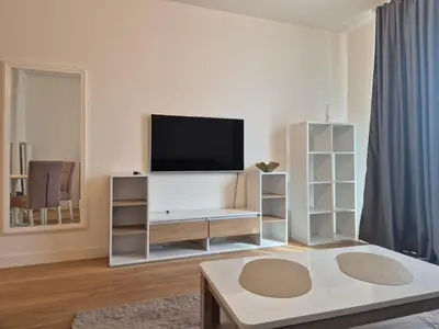 a living room with a flat screen tv on a wall at Q4, flat near Gallery shopping mall with garage in Belgrade