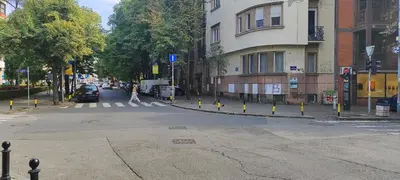 an empty street with yellow poles on the side of the road at The Best Offer in Belgrade