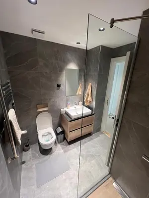 a bathroom with a toilet and a sink and a shower at BW Simfonia Apartman 407-whit free garage parking in Belgrade