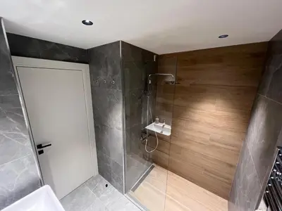 a bathroom with a shower with a glass door at BW Simfonia Apartman 407-whit free garage parking in Belgrade
