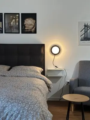 a bedroom with a bed and a chair at Sleep&Fly 1 Belgrade in Belgrade