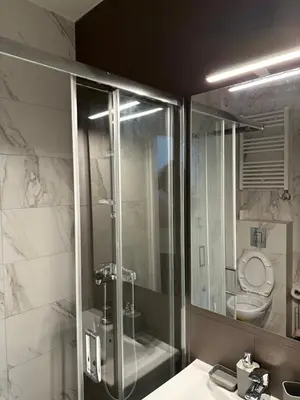 a bathroom with a shower and a sink and a toilet at Sleep&Fly 1 Belgrade in Belgrade
