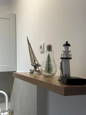 a shelf with a glass bottle and a router on it at Sleep&Fly 1 Belgrade in Belgrade