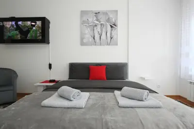 a bedroom with a bed with two pillows on it at Apartment Moonstone 3 in Bežanija