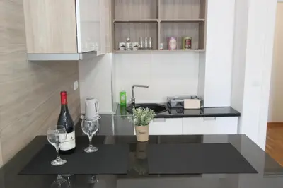 a kitchen with two wine glasses and a sink at Apartment Moonstone 3 in Bežanija