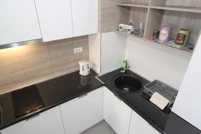 a small white kitchen with a sink in it at Apartment Moonstone 3 in Bežanija