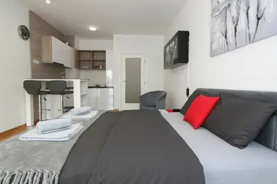 a large bed in a room with a red pillow at Apartment Moonstone 3 in Bežanija