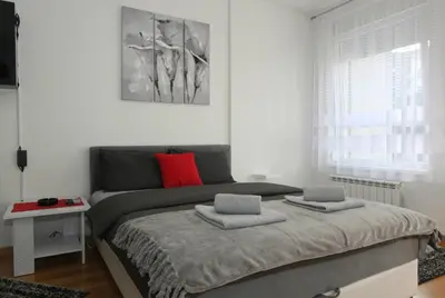 a bedroom with a bed with two pillows on it at Apartment Moonstone 3 in Bežanija